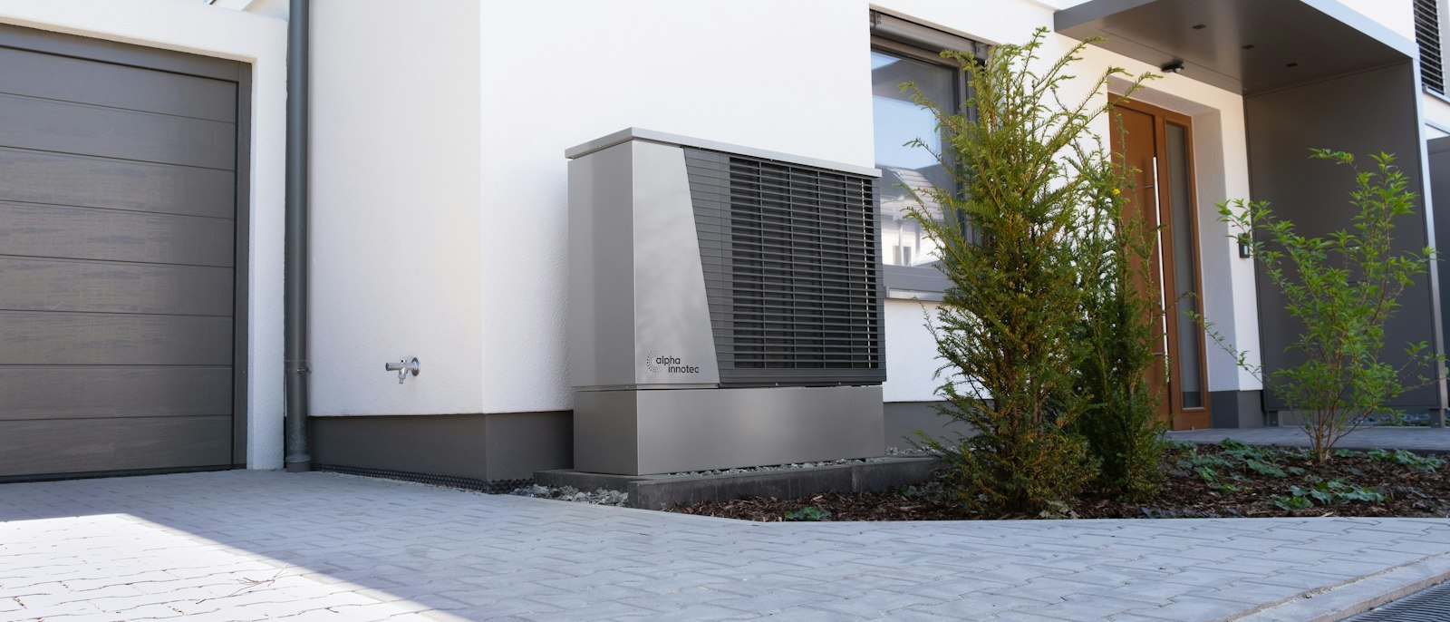 A heat pump unit outside a modern house